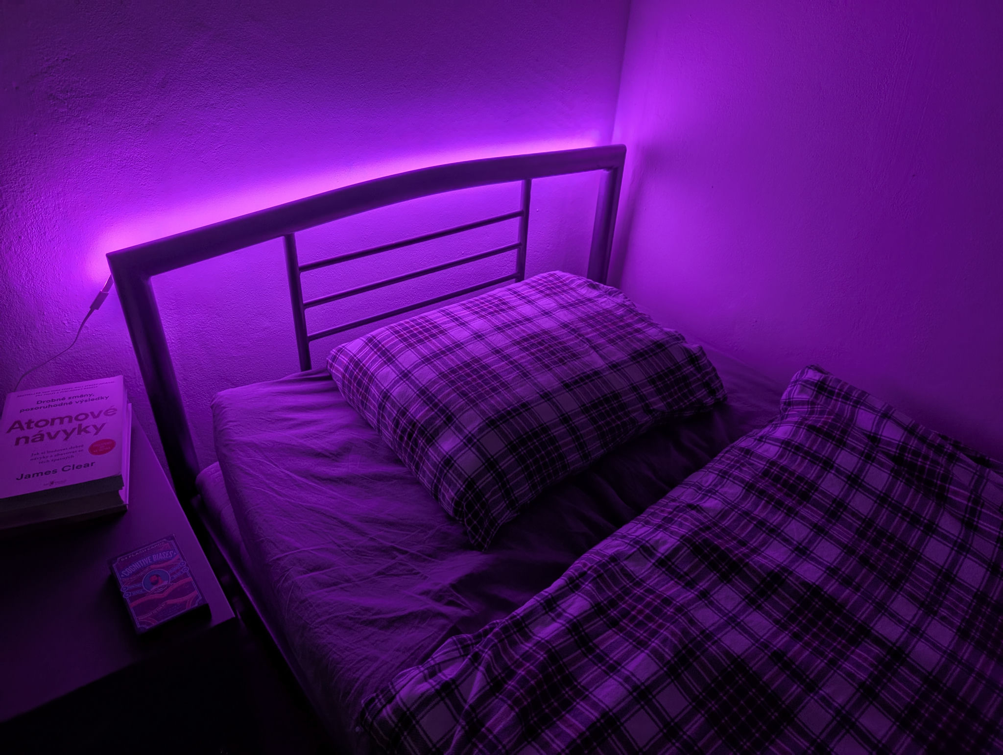 My bed covered in a purple LED light